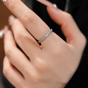 Elegant close-up view of a minimalist silver ring set with tiny blue zircon stones