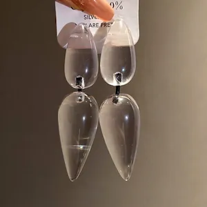 Minimalist resin teardrop drop earrings with silver pins for a stylish and elegant look.