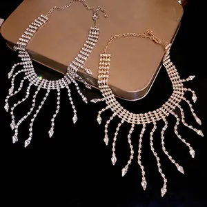 Elegant rhinestone tassel necklace with teardrop crystal charms in silver and gold tones.