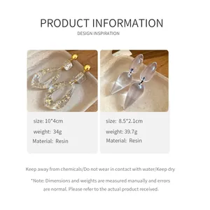 Elegant resin drop earrings with gold foil and clear teardrop design details.