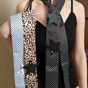 Close-up of leopard and polka dot scarves with black star leather patches and studs.