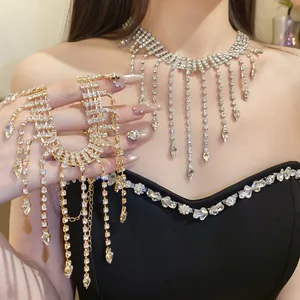 Close-up detail of luxury rhinestone waterdrop tassel necklace worn by an elegant model