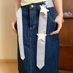 Detail view of a polka dot scarf with star patches styled as a decorative belt.