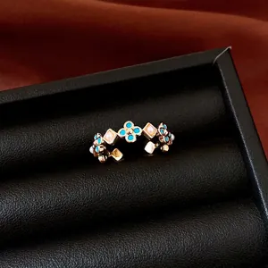 Elegant vintage-style flower ring with blue turquoise stones and pink pearls on gold band