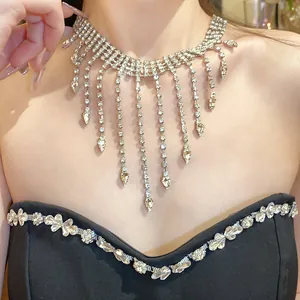 Detailed close-up showing the sparkling rhinestone waterdrop tassel necklace on a model