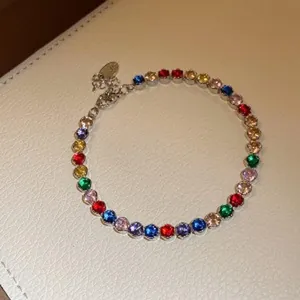 Close-up of elegant gold-plated bracelet featuring vibrant multicolored zircon stones