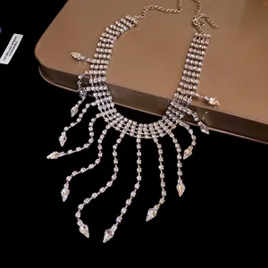 Close-up detail of silver rhinestone tassel necklace with water-drop crystal drops