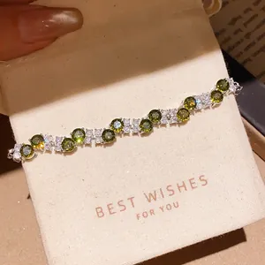 Detail view of luxury green zircon flower bracelet displayed on premium gift box padding