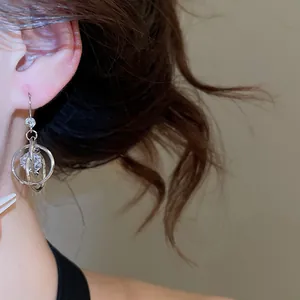 Detailed view of stylish multilayer circular zircon hook earrings on a female ear