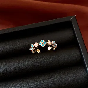 Close-up of vintage flower ring with turquoise and pink seed pearls in jewelry box.
