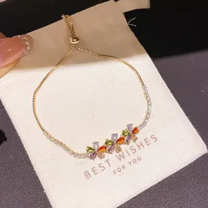 Close-up detail of a gold-plated zircon flower bracelet displayed on a gift pouch
