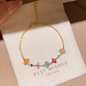 Elegant detailed close-up of a gold-plated zircon flower bracelet on a white gift pouch.