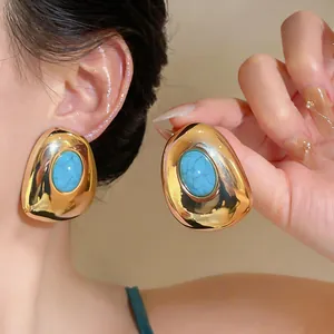 Vintage gold geometric oval stud earrings featuring a turquoise resin inlay detail