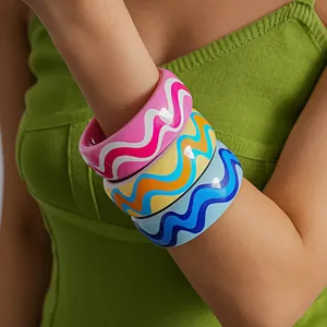 Detailed macro view of colorful dopamine resin bangles with vibrant wavy patterns