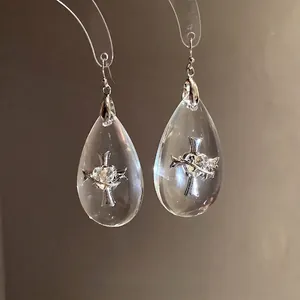 Elegant silver needle resin teardrop earrings featuring a delicate heart and cross design