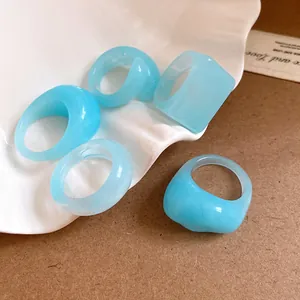 Detailed macro view of blue translucent resin rings with unique geometric designs.