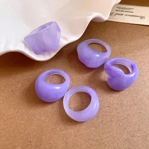 Close-up of lavender resin geometric rings with marble texture details and folds