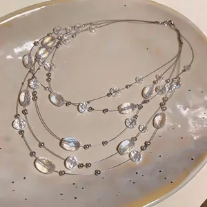Elegant Bohemian multi-layer necklace featuring clear crystal beads on a ceramic plate