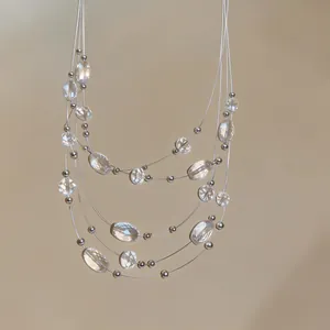 Detailed close-up of bohemian multi-layered necklace featuring clear crystal beads