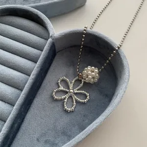 Elegant Korean style pearl flower necklace with silver ball chain displayed on blue velvet heart box