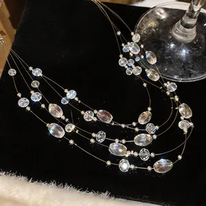 Close-up of bohemian multi-layer necklace with sparkling clear crystal beads on black velvet