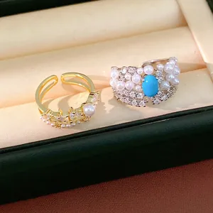 Elegant palace style pearl and zircon rings with turquoise stone in a jewelry box