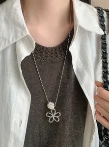 Detail shot of a Korean-style silver long necklace with a pearl flower pendant