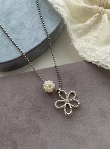 Close-up detail of a Korean style pearl flower necklace with an elegant silver ball chain