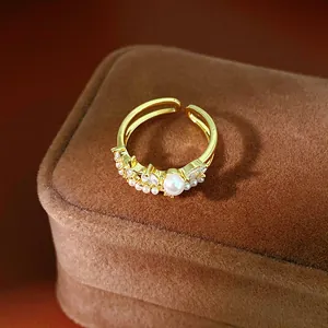 Close-up detail of an elegant gold pearl ring featuring zircon inlay and a vintage design