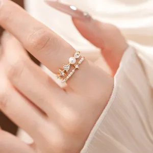 Detailed macro shot of elegant gold rings set with pearls and heart-shaped zircons