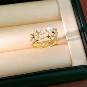 Close-up of vintage style gold ring with heart zircon and pearl details in jewelry box