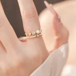 Detailed macro shot of vintage-style gold rings with white pearls and sparkling zircons