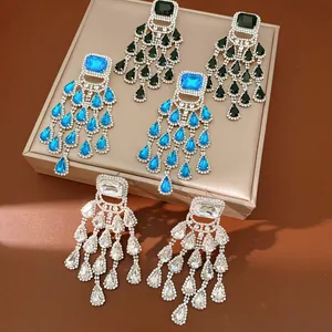 Detailed view of rhinestone tassel earrings in blue, black and clear gems.