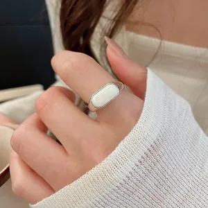 Detailed view of an 18k gold plated minimalist resin open ring worn on an index finger