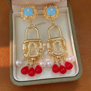 Exquisite vintage gold lock tassel earrings with pearls and red beads for women