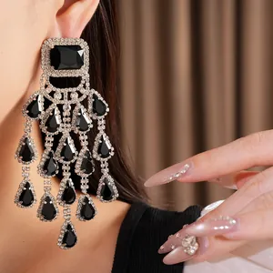 Close-up of elegant black teardrop tassel earrings with sparkling rhinestones