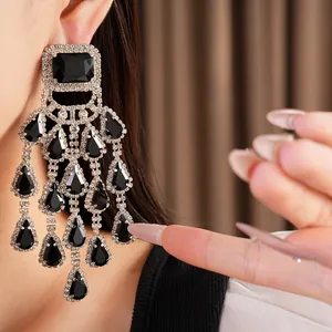 Close-up of elegant black tiered tassel earrings with silver-toned rhinestones