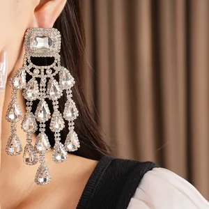 Glamorous oversized chandelier earrings with shimmering water drop rhinestones in silver.