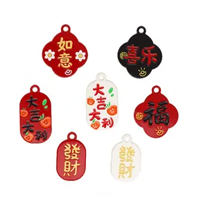 Detailed view of alloy charms with Chinese blessing characters and oil-drop finish.
