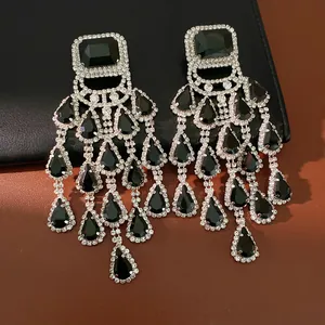 Detailed close-up of luxury black teardrop tassel chandelier earrings with rhinestone accents