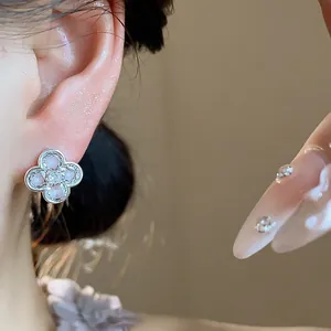 Detailed macro view of pink enamel flower stud earring with a central zircon inlay