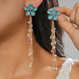 Detail view of blue flower tassel earrings with pearls and colored beads