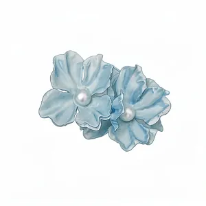 Light blue fabric flower hair clip with pearl centers for seaside vacation style