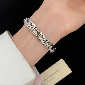 Close-up of stainless steel Italian charm bracelet with cute enamel puppy faces.