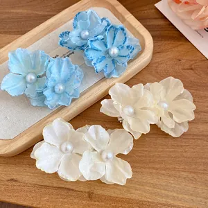 Elegant blue and cream fabric flower hair clips with pearl centers for beach vacation.
