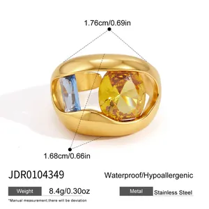 Detail view of gold hollow stainless steel ring with yellow and blue zircon stone specs
