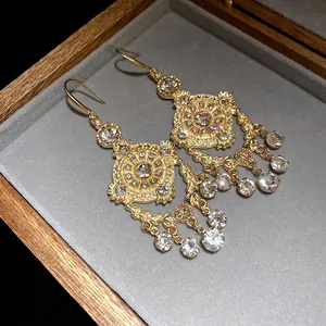 Vintage palace style wheat-ear gold earrings with dangling rhinestones in jewelry box