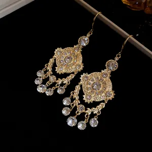 Detailed view of vintage court-style gold earrings with rhinestone wheat ear motifs