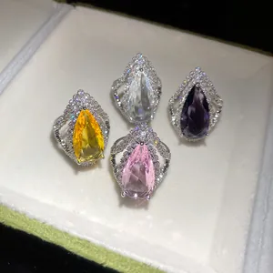 Macro view of teardrop zircon open rings in yellow, purple, pink, and clear colors
