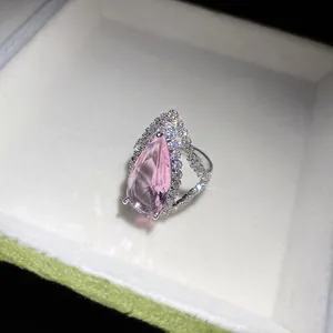 Detail view showing the sparkling pink teardrop zircon and pavé crystal setting on silver ring